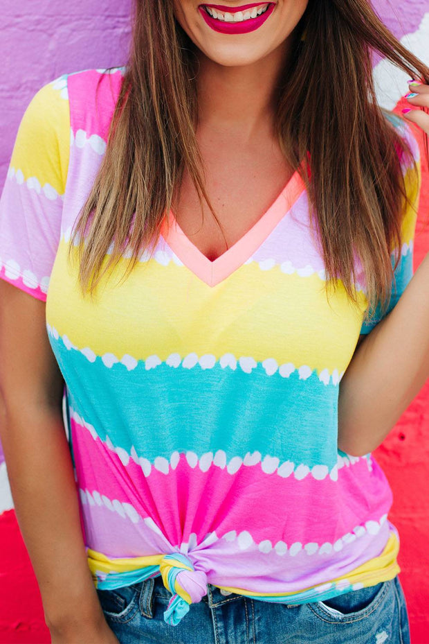 a woman wearing a colorful shirt and hat