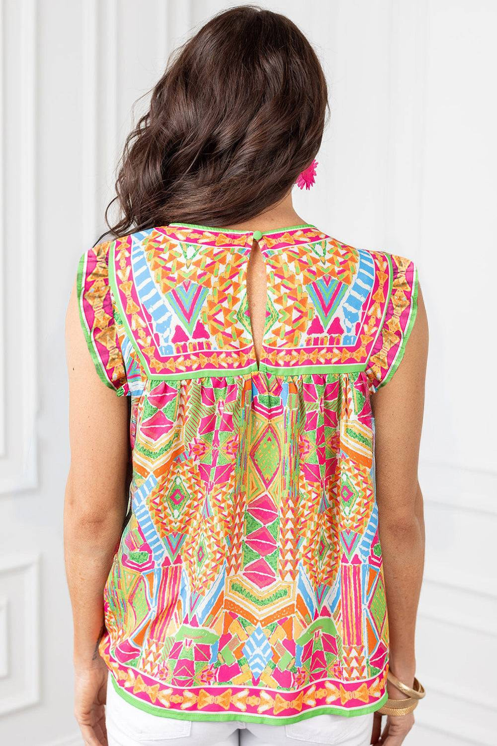 the back of a woman wearing a colorful top