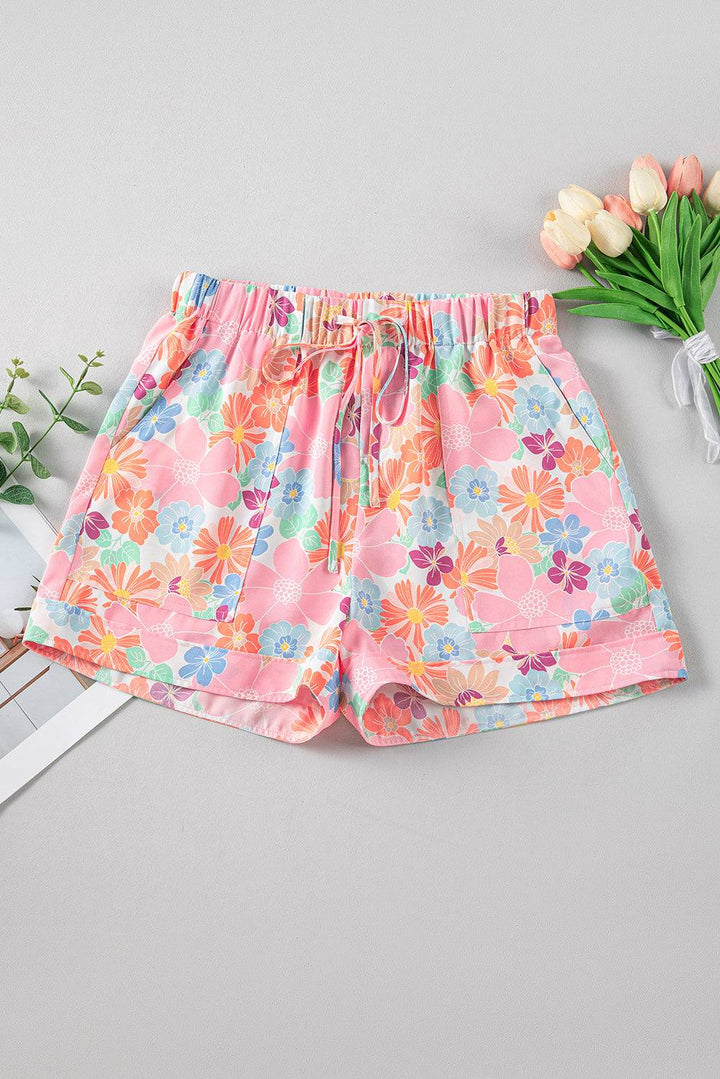 a pair of shorts with flowers on them next to a bouquet of flowers