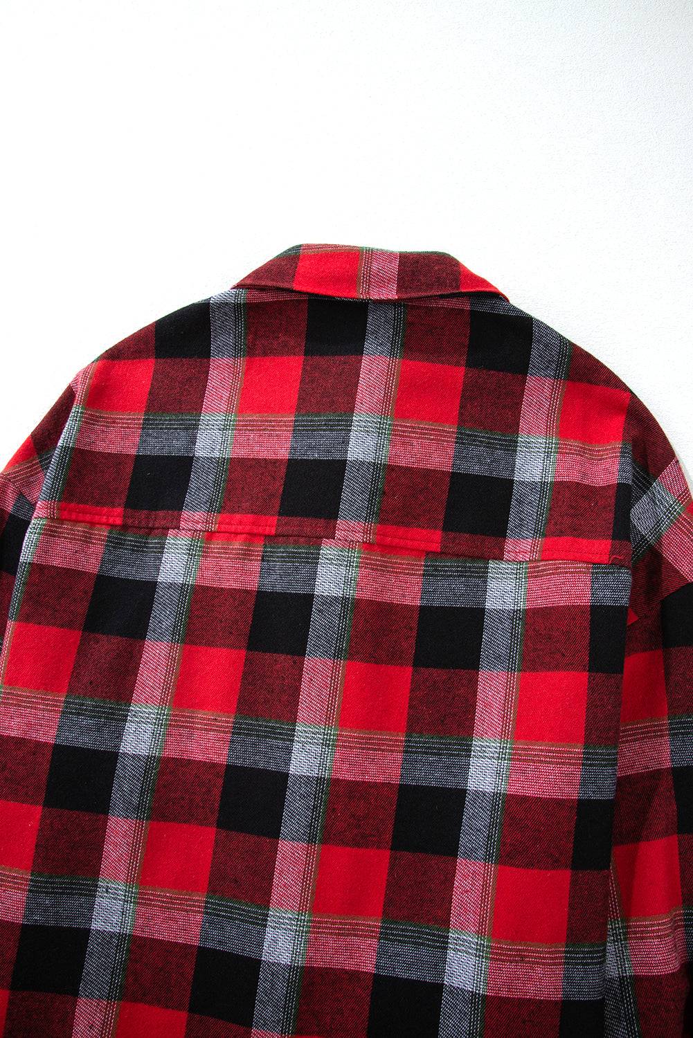 a red and black checkered shirt hanging on a wall