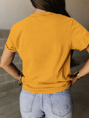 a woman wearing a yellow shirt and jeans