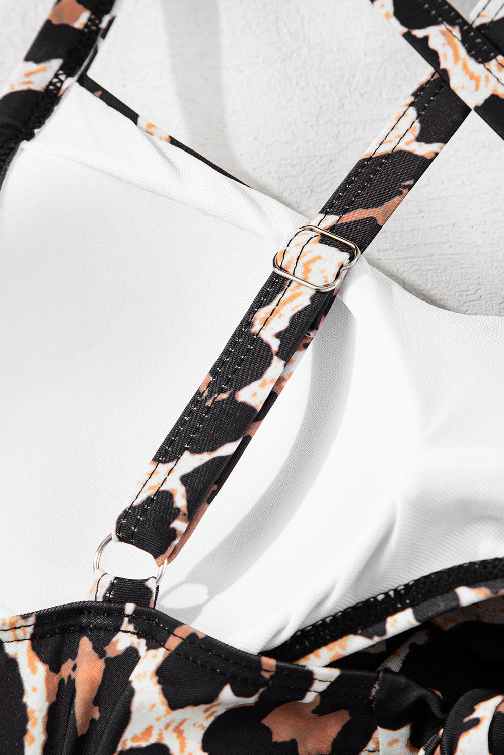 Adjustable strap detail of Black Leopard 2-tone Monokini with metal hardware for a custom fit, shop now at Faith & Co. Boutique.