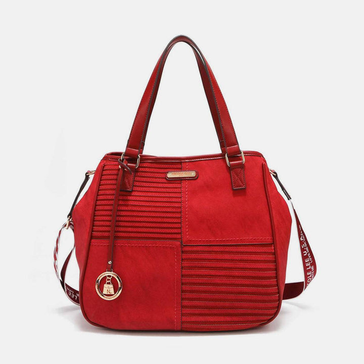 a red handbag with a zippered design on the front