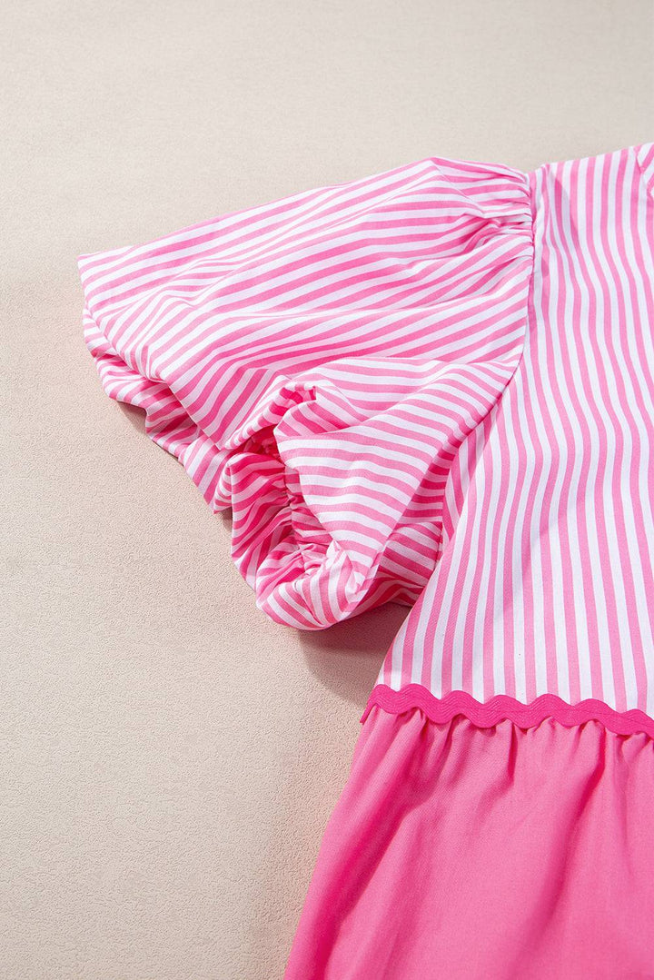 a pink and white striped dress laying on the ground