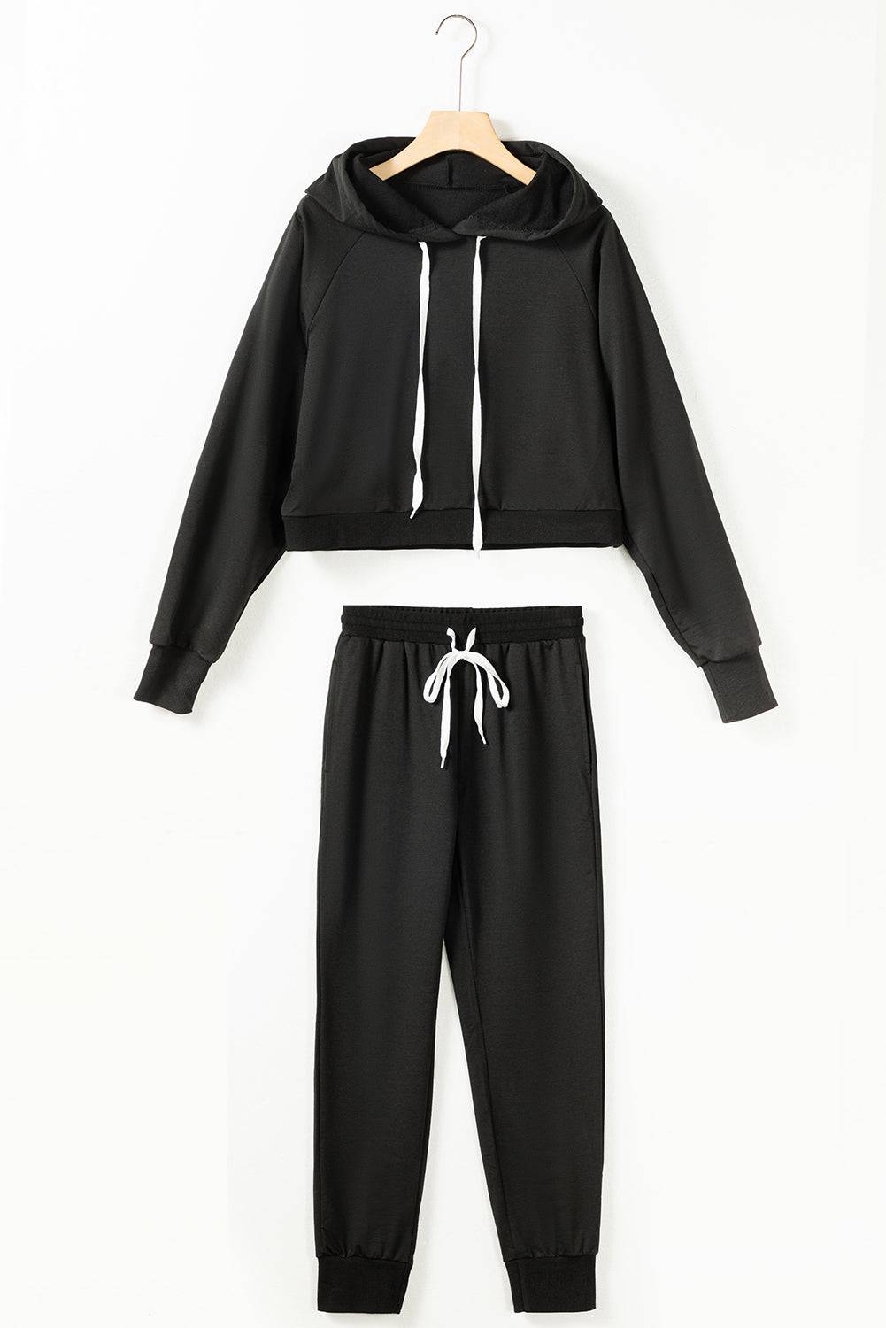 a black sweatshirt and sweatpants with white drawstrings