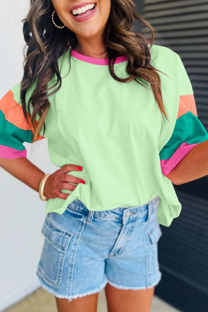 a woman wearing a green and pink top