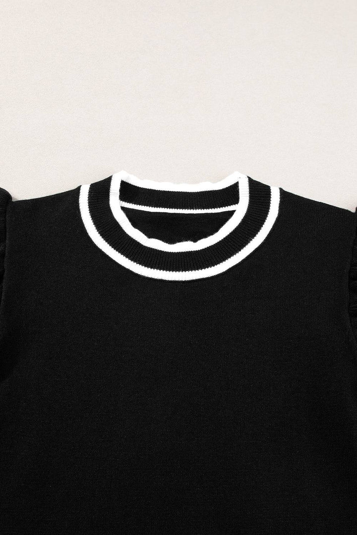 a black shirt with a white collar on a hanger