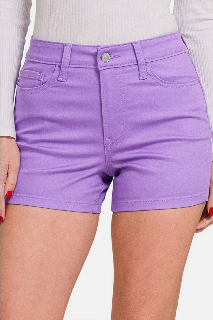 a close up of a person wearing purple shorts