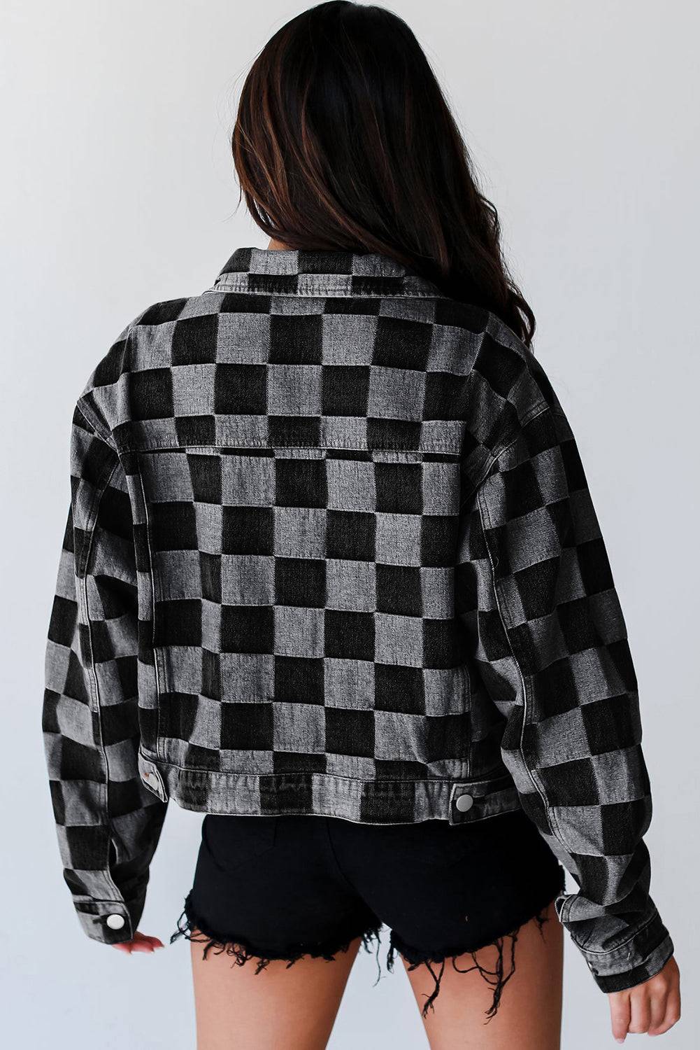 Back view of black checkered patchwork denim jacket, a stylish fall outerwear option. Available at Faith & Co. Boutique.