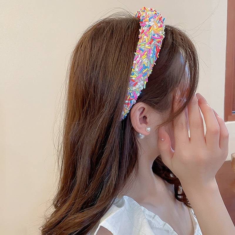 a woman with a colorful hair tie on her head