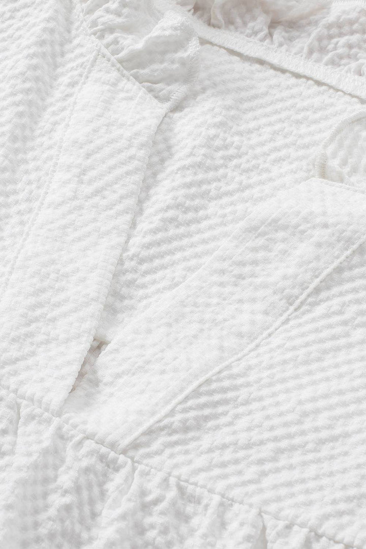 a close up of a bed with a white comforter