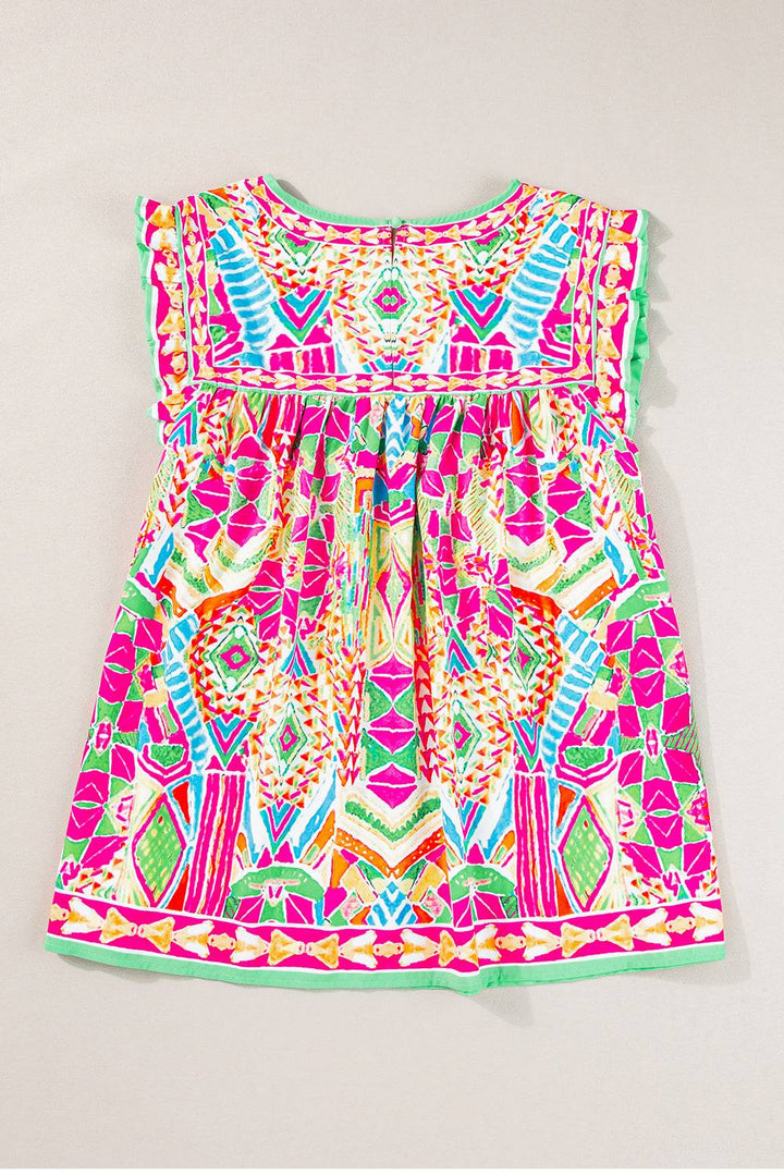 a pink dress with a colorful pattern on it