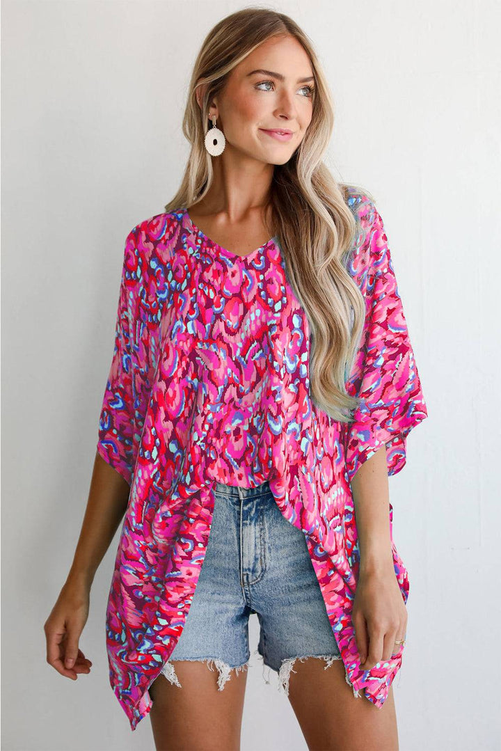 Pink Abstract Print V Neck Half Sleeve Loose Fit Tunic Blouse styled with denim shorts, perfect for summer boho looks at Faith & Co. Boutique.