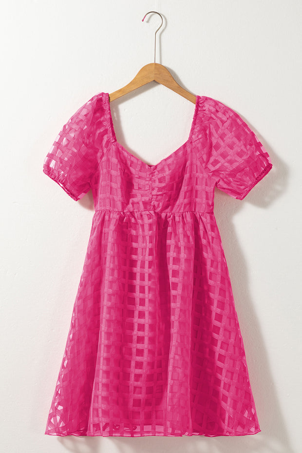 a pink dress hanging on a hanger