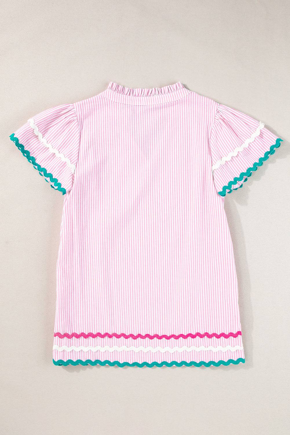 a pink and white striped dress with blue trim