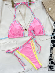 a woman's pink and yellow swimsuit and a purse