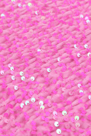 a close up of pink sequins on fabric