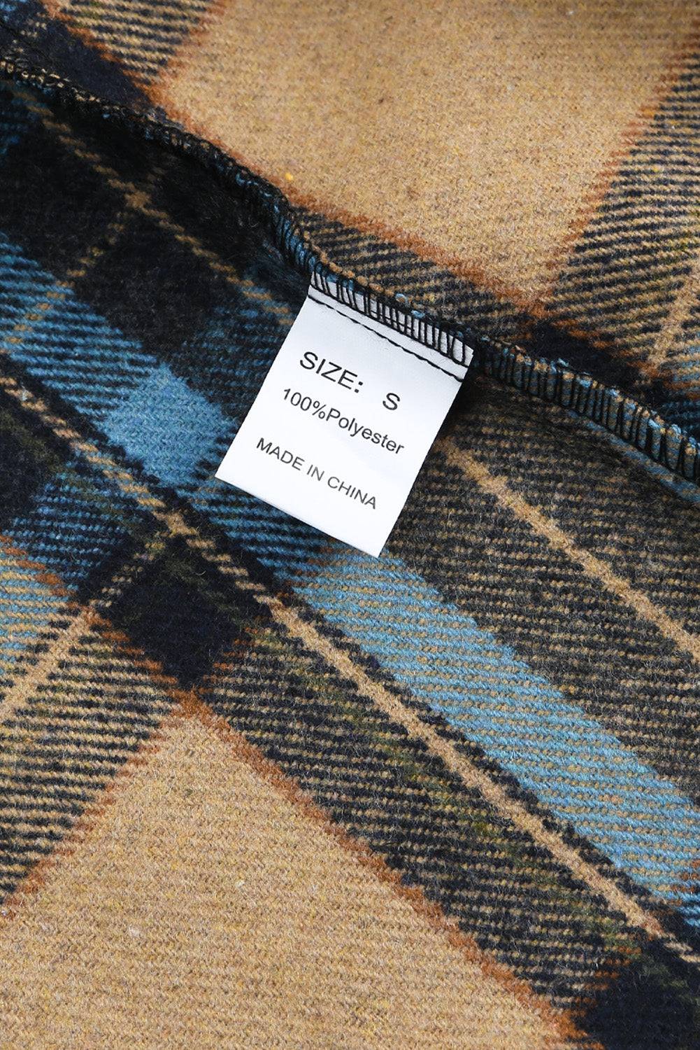 a label on a blue and brown plaid shirt