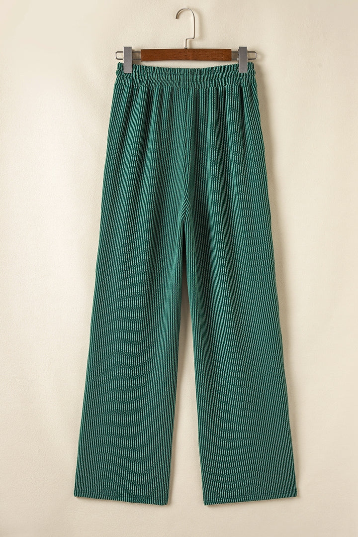 Back view of green Evergreen JOLLY Corded Pants with elastic waistband. Comfortable holiday pants from Faith & Co. Boutique.