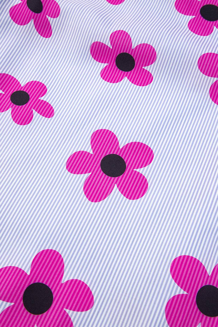 a pink and black flower on a white background