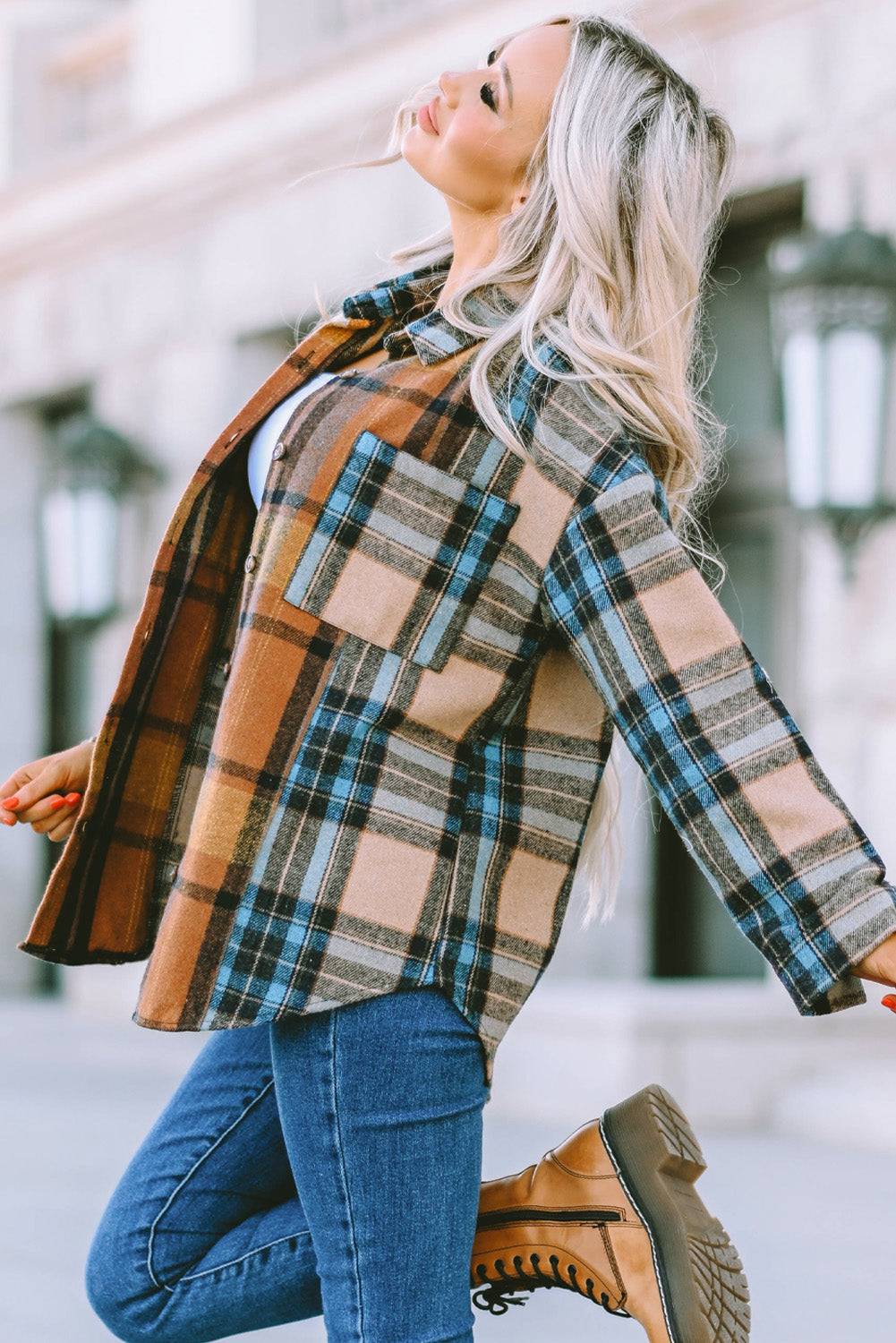 a woman is walking down the street in a plaid jacket