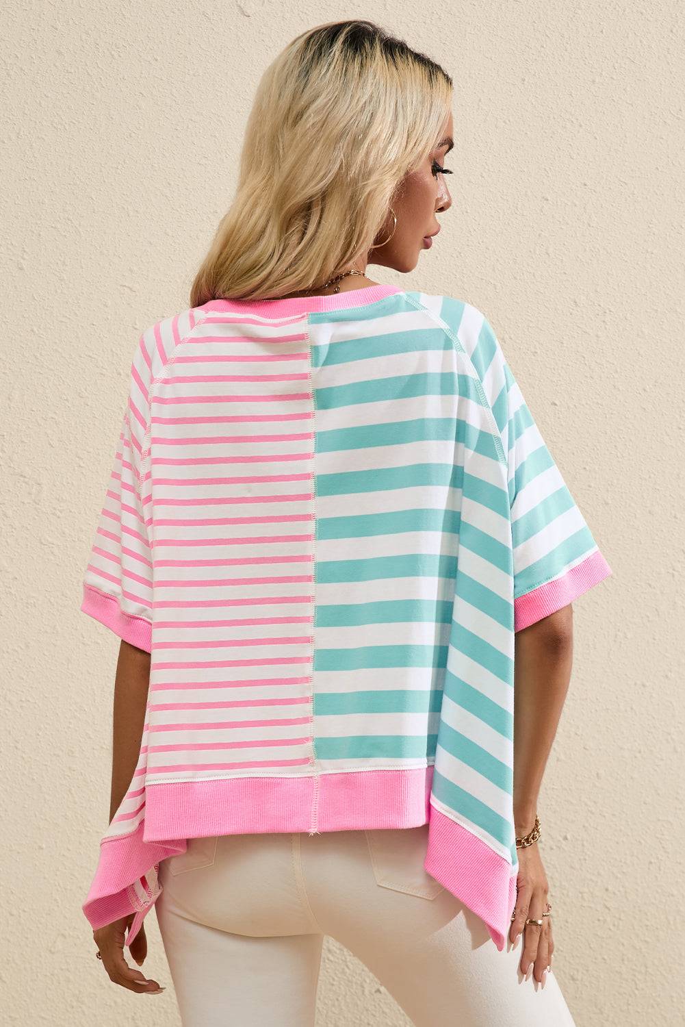 a woman wearing a pink and blue striped top