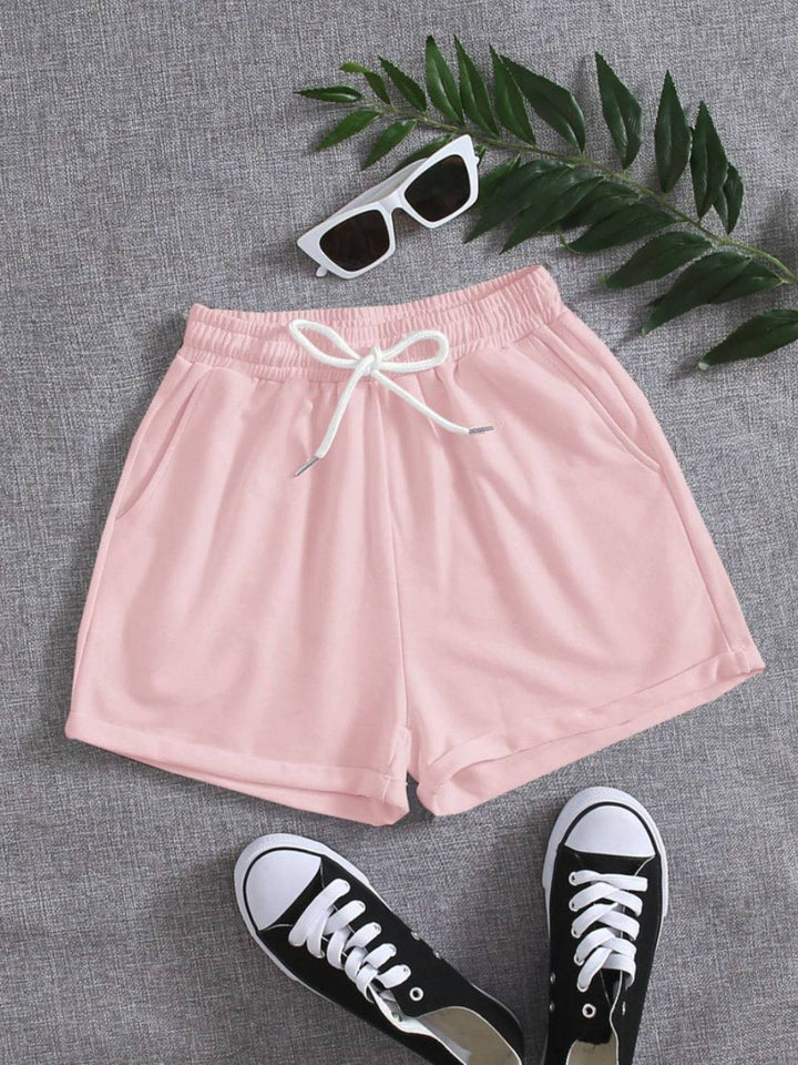 a pair of pink shorts with a pair of black sneakers