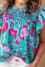 a little girl wearing a blue and pink top