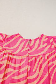 a close up of a pink and orange dress