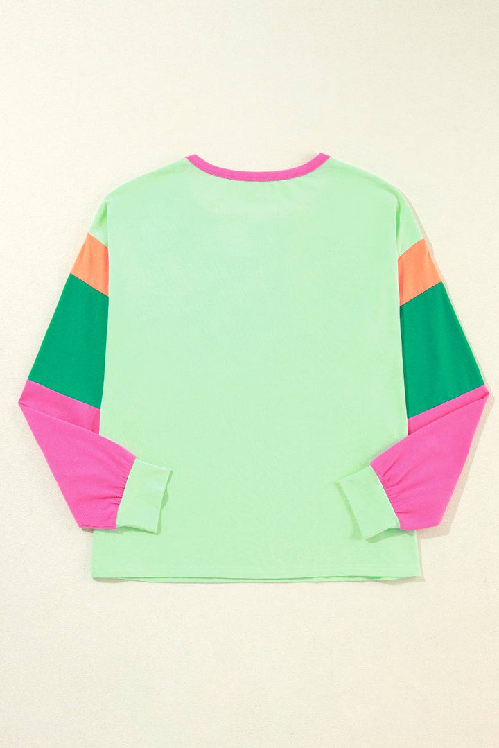 a green shirt with pink and green sleeves