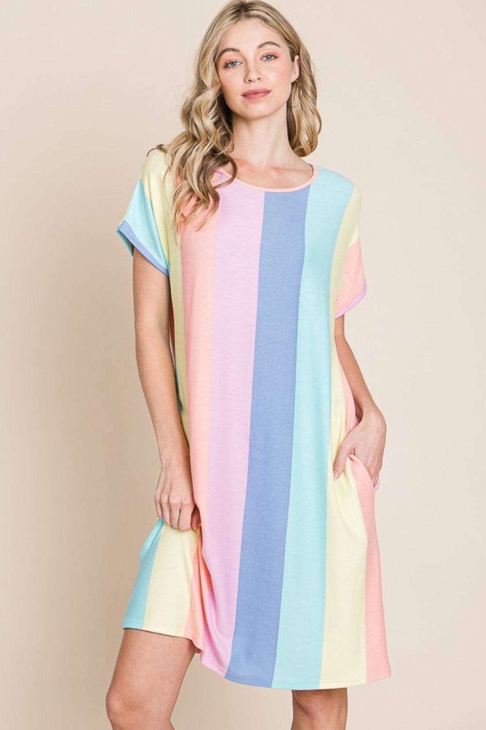a woman wearing a multicolored shift dress
