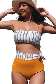 a woman wearing a bikini top and a hat