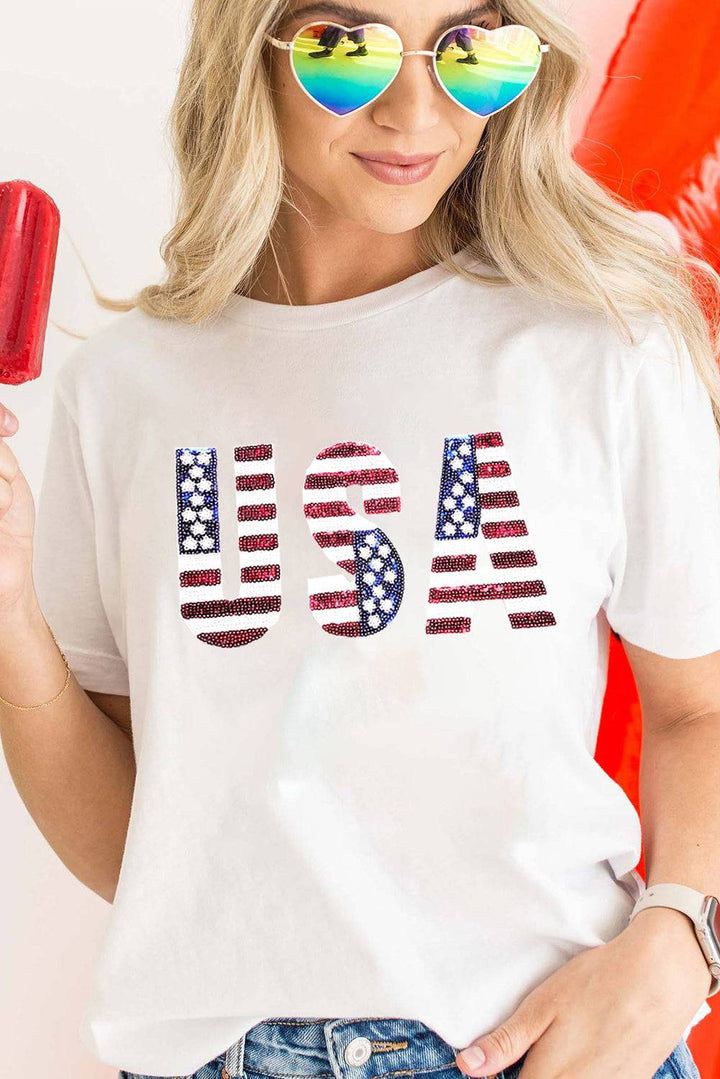 a woman wearing a usa flag t - shirt holding a popsicle