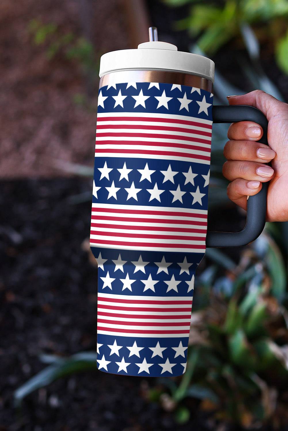a person holding a coffee cup with stars on it