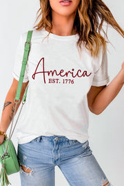 a woman wearing a white shirt with the word america on it