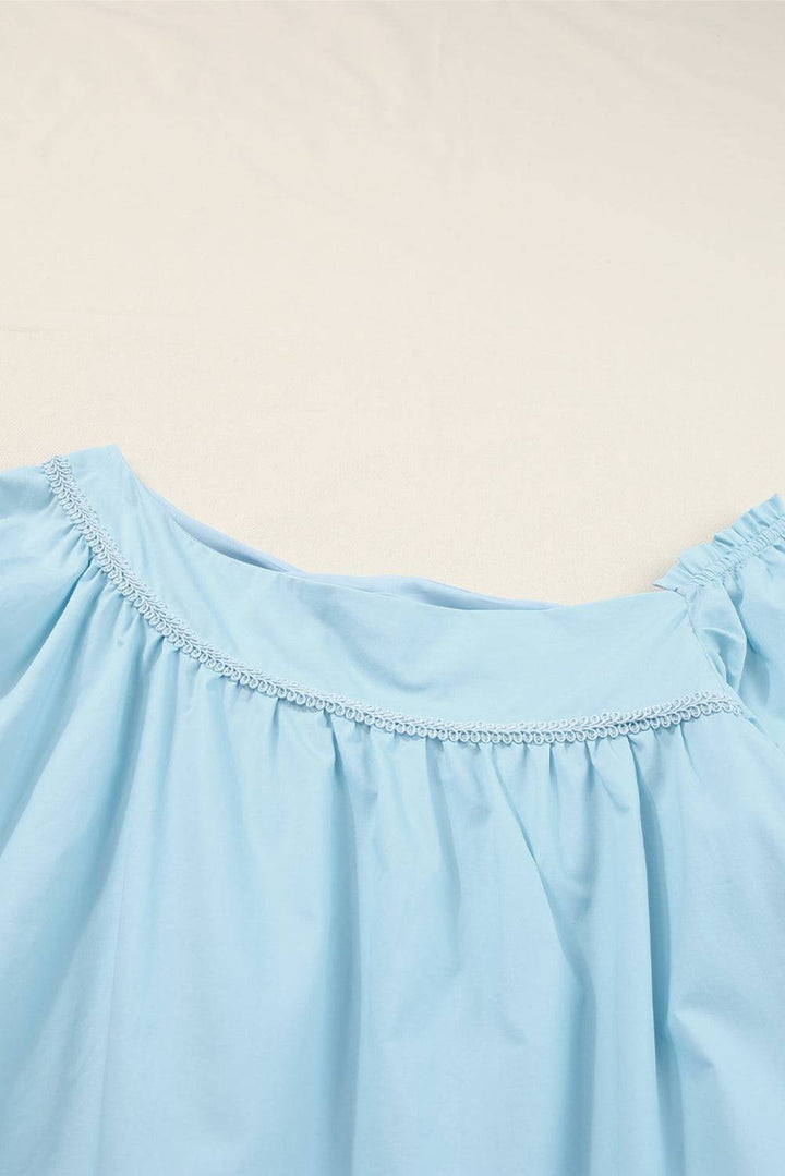 a close up of a blue dress on a bed
