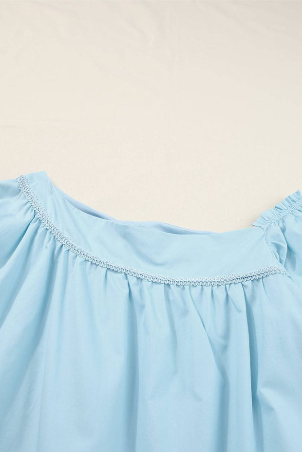 a close up of a blue dress on a bed