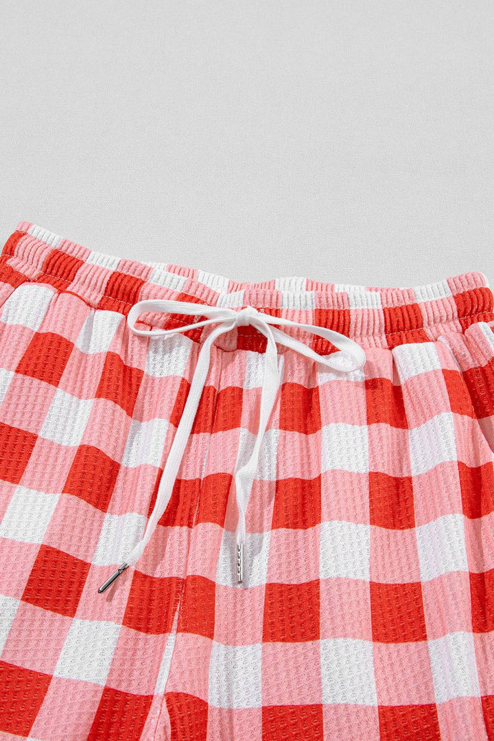 a close up of a red and white checkered shorts