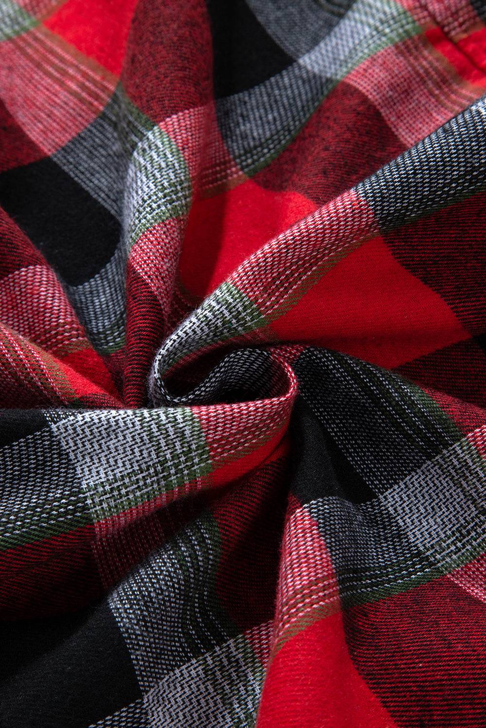 a close up of a red and black plaid fabric