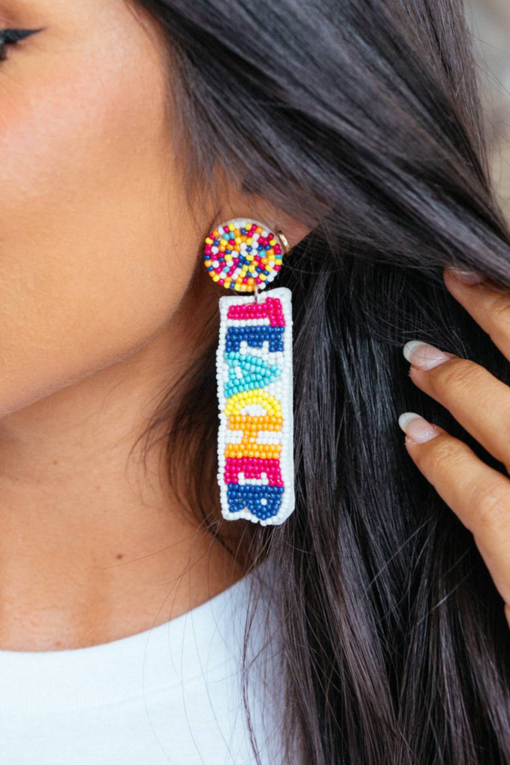 a woman wearing a pair of colorful beaded earrings