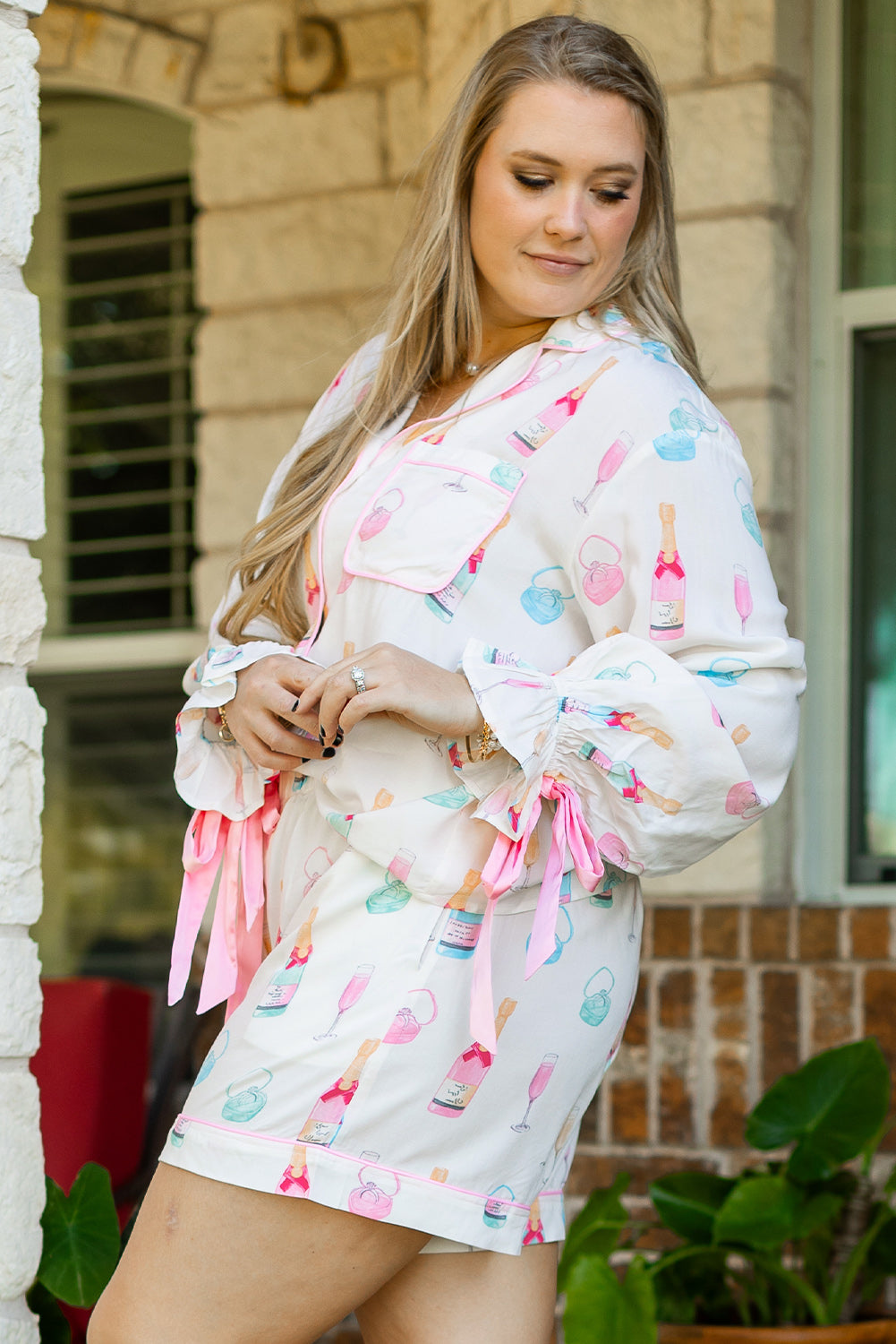 White Plus Size Wine Glass Print Bow Knot Pajama Set with pink ribbon ties and vibrant wine bottle graphics, available at Faith & Co. Boutique.