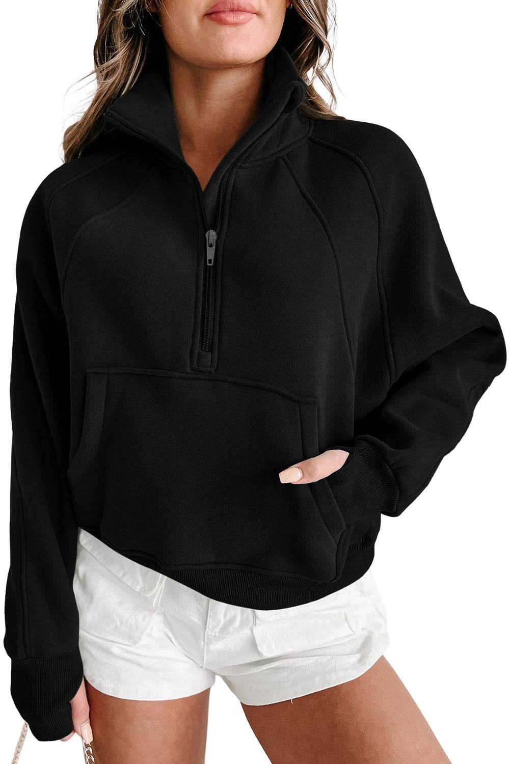 a woman wearing a black sweatshirt and white shorts