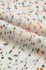 a close up of a white knitted blanket