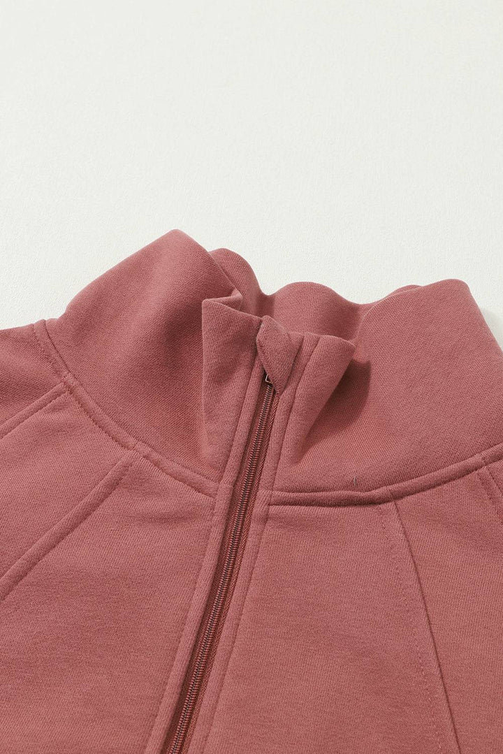 a close up of a pink jacket with a zipper