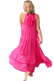 a woman in a pink dress is walking