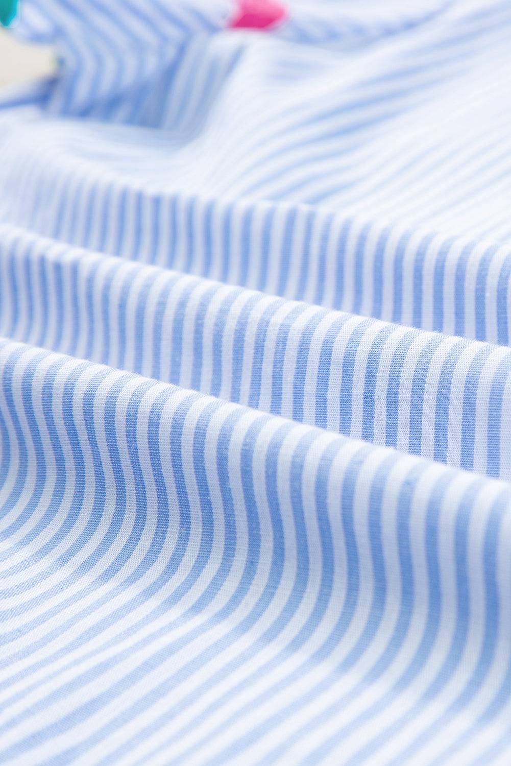 a close up of a blue and white striped shirt