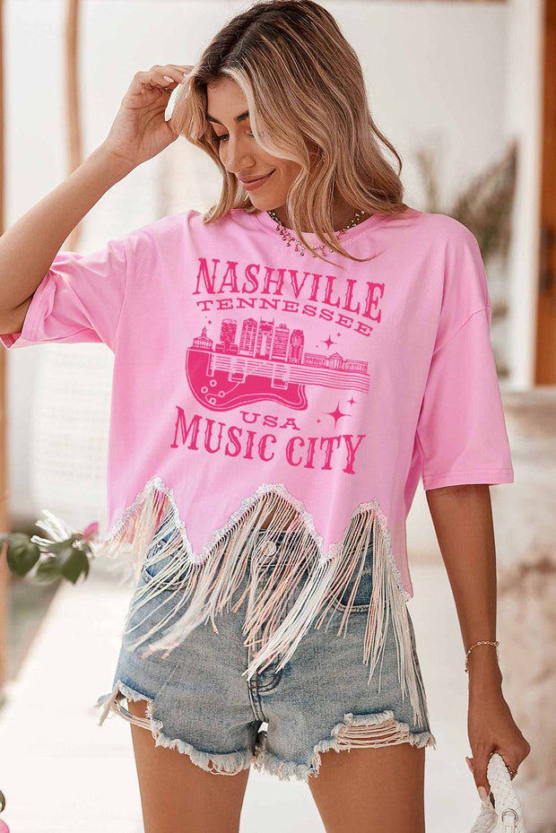 a woman wearing a pink nashville music city shirt