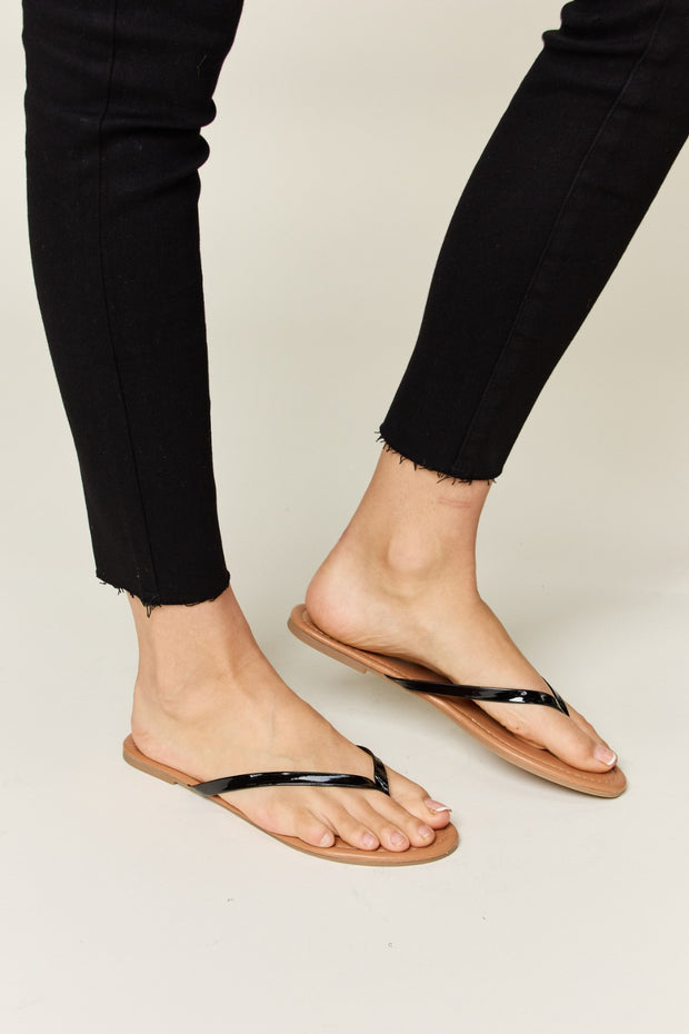 a person wearing black sandals and black pants