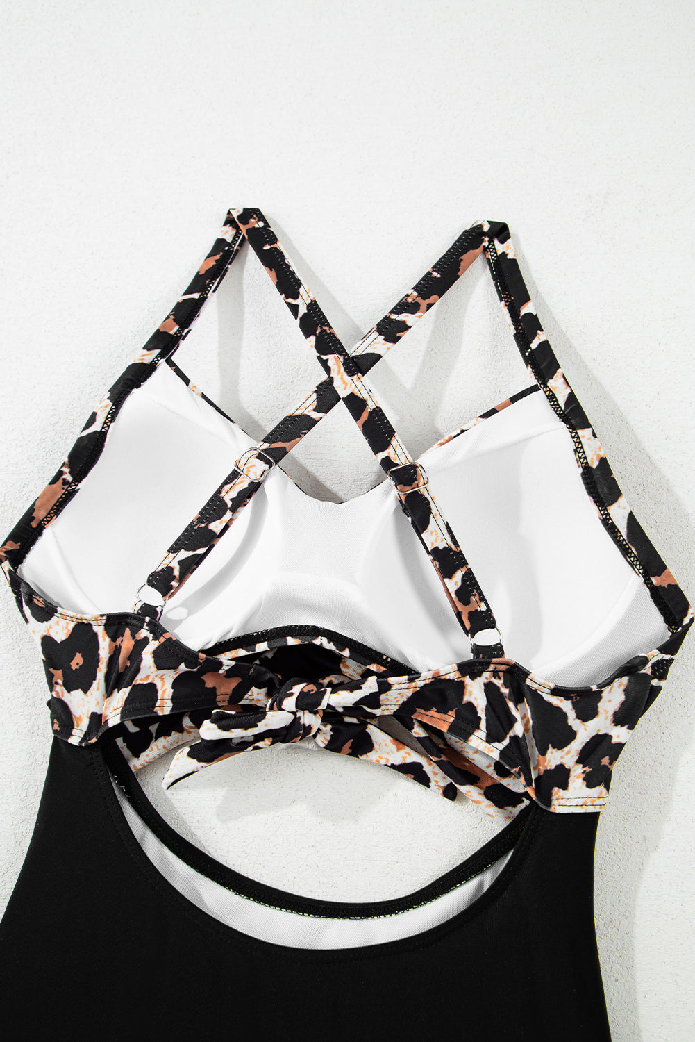 Interior view of Black Leopard 2-tone Monokini top with padded cups and crisscross straps, designed for support and style.