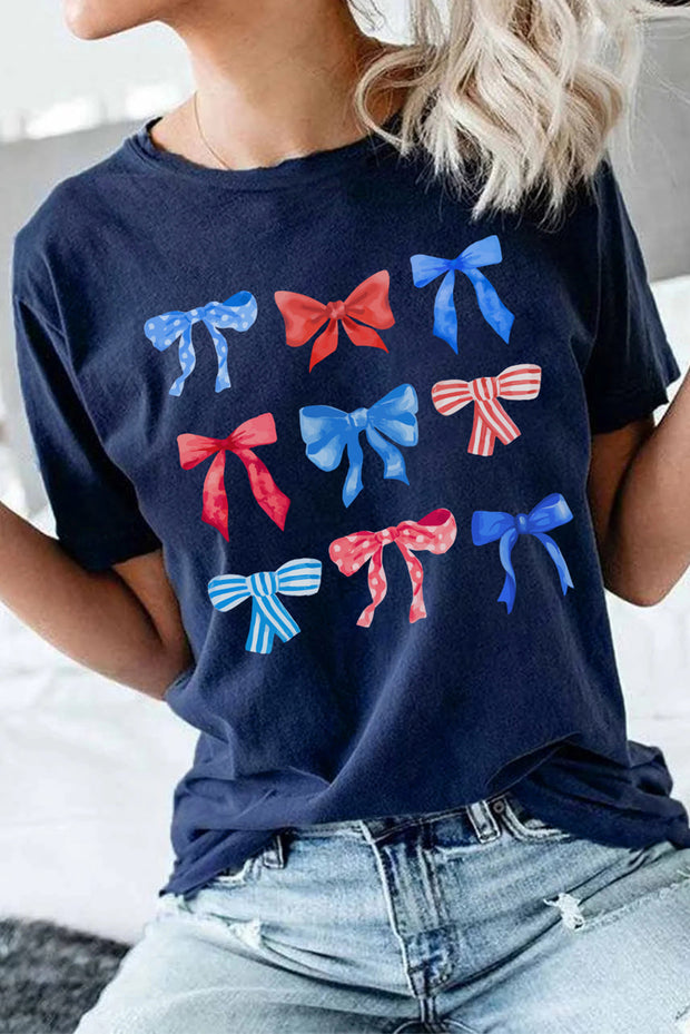 a woman wearing a blue shirt with red, white and blue bows on it
